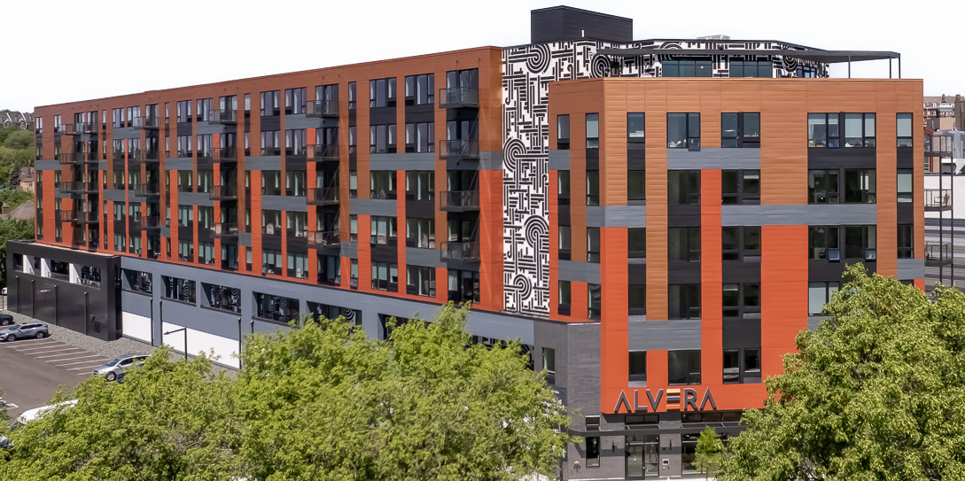 Multi-story apartment building with orange and gray EIFS cladding
