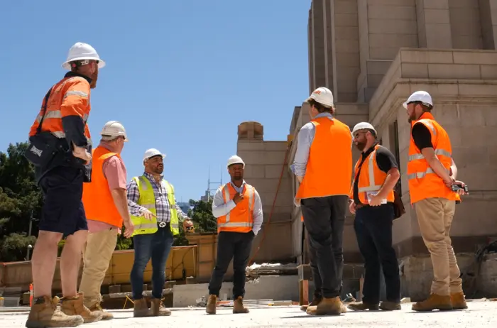 group of construction workers with safety vests and hard hats